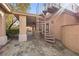 Backyard showcasing a spiral staircase leading to a balcony and covered patio at 7450 Via Olivero Ave, Las Vegas, NV 89117