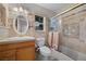 Bathroom featuring shower stall, a sink and toilet, and patterned tile walls at 7450 Via Olivero Ave, Las Vegas, NV 89117