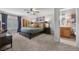 Bedroom with comfortable bed and view into adjacent bathroom at 7450 Via Olivero Ave, Las Vegas, NV 89117