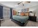 Comfortable bedroom featuring carpet floors, ceiling fan, and blue curtains for a relaxing ambiance at 7450 Via Olivero Ave, Las Vegas, NV 89117