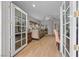 Bedroom featuring wooden floors, ceiling fan and doors to the backyard, great natural lighting at 7450 Via Olivero Ave, Las Vegas, NV 89117