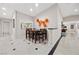 Bright dining area with elegant marble floors, custom artwork, and plenty of light at 7450 Via Olivero Ave, Las Vegas, NV 89117