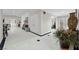 Grand foyer featuring sleek tiled floors, decorative vase and furnishings, and a view towards the living spaces at 7450 Via Olivero Ave, Las Vegas, NV 89117