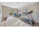 Bright exercise room featuring a treadmill, patio access, and natural light at 7450 Via Olivero Ave, Las Vegas, NV 89117