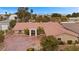 Inviting single-story home with a terra cotta roof, lush landscaping and a circular driveway at 7450 Via Olivero Ave, Las Vegas, NV 89117