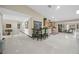 Open floor plan featuring a table and chairs, cabinetry, a wine fridge, and tile floors at 7450 Via Olivero Ave, Las Vegas, NV 89117