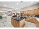 Open-concept kitchen with marble floors, kitchen island, and stainless steel appliances at 7450 Via Olivero Ave, Las Vegas, NV 89117