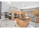 Spacious kitchen with island cooktop and stainless steel appliances at 7450 Via Olivero Ave, Las Vegas, NV 89117