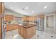 Spacious kitchen with stainless steel appliances, kitchen island and stone countertops at 7450 Via Olivero Ave, Las Vegas, NV 89117