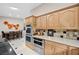 Bright kitchen featuring stainless steel appliances, tiled backsplash, and a view to the breakfast nook at 7450 Via Olivero Ave, Las Vegas, NV 89117