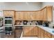 This kitchen features light wood cabinetry and stainless steel appliances, offering a blend of style and functionality at 7450 Via Olivero Ave, Las Vegas, NV 89117