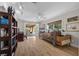 Comfortable living room featuring a daybed, wood floors, ceiling fan, and access to covered patio at 7450 Via Olivero Ave, Las Vegas, NV 89117