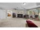 Cozy living room featuring a fireplace, comfortable seating, and natural light from a window at 7450 Via Olivero Ave, Las Vegas, NV 89117