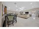 Open concept living and dining area with tile floors, skylights, and a neutral color palette at 7450 Via Olivero Ave, Las Vegas, NV 89117