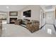 Cozy living room featuring a fireplace and comfortable seating, with tile floors and a vaulted ceiling at 7450 Via Olivero Ave, Las Vegas, NV 89117