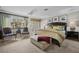 Well-lit main bedroom with a large bed, accent chairs, and a view to an outdoor patio at 7450 Via Olivero Ave, Las Vegas, NV 89117