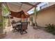 Relaxing outdoor seating area with a pergola and lush greenery, perfect for entertaining at 7450 Via Olivero Ave, Las Vegas, NV 89117