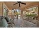 Inviting outdoor patio with comfortable seating and a beautiful spiral staircase leading to the upper level at 7450 Via Olivero Ave, Las Vegas, NV 89117