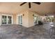 Expansive covered patio with stone floors and spiral staircase access at 7450 Via Olivero Ave, Las Vegas, NV 89117