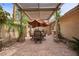 Inviting outdoor patio featuring a pergola, dining set, brick pavers, and mature landscaping at 7450 Via Olivero Ave, Las Vegas, NV 89117