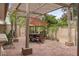 Outdoor patio with a pergola, brick flooring, and outdoor seating surrounded by desert landscaping at 7450 Via Olivero Ave, Las Vegas, NV 89117