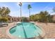 Relaxing private pool surrounded by palm trees, brick patio and cozy lounge seating at 7450 Via Olivero Ave, Las Vegas, NV 89117