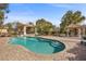 Backyard pool with surrounding brick patio and shaded cabanas at 7450 Via Olivero Ave, Las Vegas, NV 89117