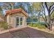 Quaint pool house with glass french doors and red brick pathway on a well landscaped property at 7450 Via Olivero Ave, Las Vegas, NV 89117