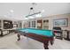 Pool table with pendant lighting, views of the outdoor seating area, and spiral staircase at 7450 Via Olivero Ave, Las Vegas, NV 89117