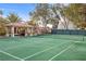 A private tennis court with a covered gazebo and bar area perfect for entertaining at 7450 Via Olivero Ave, Las Vegas, NV 89117