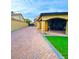 Backyard patio with pavers, covered seating and artificial turf at 7874 Clearwood Ave, Las Vegas, NV 89123