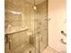 Walk-in shower with grab bars and tiled walls at 7874 Clearwood Ave, Las Vegas, NV 89123