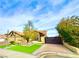 Landscaped front yard with a modern gate and paved driveway at 7874 Clearwood Ave, Las Vegas, NV 89123