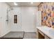 Modern bathroom with a large walk-in shower and patterned wallpaper at 7923 Canoe Ln, Las Vegas, NV 89145