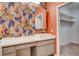 Bright bathroom with a modern vanity and patterned wallpaper at 7923 Canoe Ln, Las Vegas, NV 89145