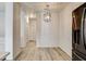 Light and bright dining area with wood-look flooring and modern lighting fixture at 7923 Canoe Ln, Las Vegas, NV 89145