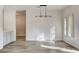 Elegant dining area with modern chandelier and hardwood floors at 7923 Canoe Ln, Las Vegas, NV 89145