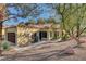 Rear view of a tan house with a brown garage door at 7923 Canoe Ln, Las Vegas, NV 89145