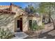 Residential home with a dark wood door and walkway at 7923 Canoe Ln, Las Vegas, NV 89145