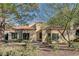 Light beige house with dark-framed windows and a tile roof at 7923 Canoe Ln, Las Vegas, NV 89145