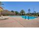 Community pool with lounge chairs and palm trees at 7923 Canoe Ln, Las Vegas, NV 89145