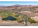 Aerial view of a luxury community with a golf course and lake at 8 Hilltop Crest St, Henderson, NV 89011