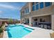 Gorgeous backyard with a large pool, built-in seating, and an outdoor kitchen perfect for entertaining at 8 Hilltop Crest St, Henderson, NV 89011