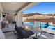 Captivating backyard patio featuring a cozy fire pit and a sparkling pool against a mountain backdrop at 8 Hilltop Crest St, Henderson, NV 89011