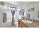 Bathroom featuring a light wood cabinet, a sink, granite counters, a white shower and tub combo, and neutral decor at 8 Hilltop Crest St, Henderson, NV 89011