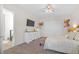 Spacious bedroom featuring a large TV, dresser, closet, and a comfortable bed with decorative pillows at 8 Hilltop Crest St, Henderson, NV 89011
