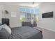 Bedroom featuring a dark wood bed and dresser set, and three large windows with natural light at 8 Hilltop Crest St, Henderson, NV 89011