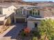 Two-story house with solar panels, a large driveway, and landscaping at 8 Hilltop Crest St, Henderson, NV 89011