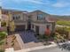 Two-story house with solar panels, double garage, and a landscaped yard at 8 Hilltop Crest St, Henderson, NV 89011