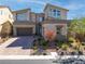 Two-story modern home with gray exterior, paver driveway, and landscaping at 8 Hilltop Crest St, Henderson, NV 89011